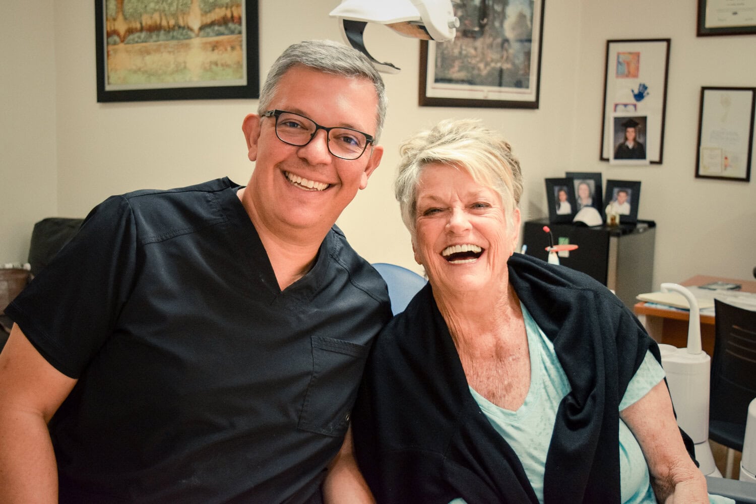 Dr. Mario Bonilla DDS with a patient after her full-arch restoration
